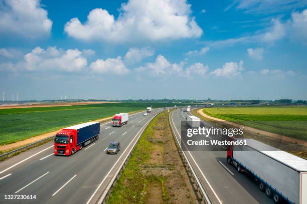 traffic along bundesautobahn 44 on sunny day - deutsche autobahn stock-fotos und bilder