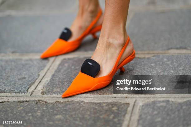 Justyna Czerniak wears neon orange pointed pumps heels shoes from Prada, outside Dior, during Paris Fashion Week - Haute Couture Fall/Winter...