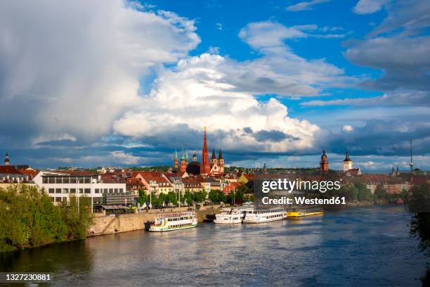germany, bavaria, wurzburg, large clouds over riverside city - würzburg stock pictures, royalty-free photos & images