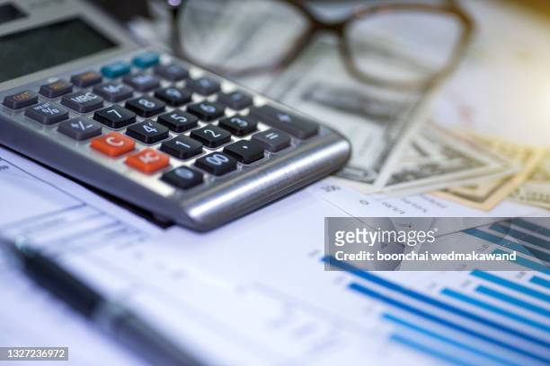 calculator, pen and summary report. paperwork.business planning and management concept. - ira account stock pictures, royalty-free photos & images