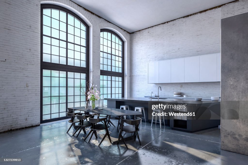 Interior of modern kitchen with large windows and dining table