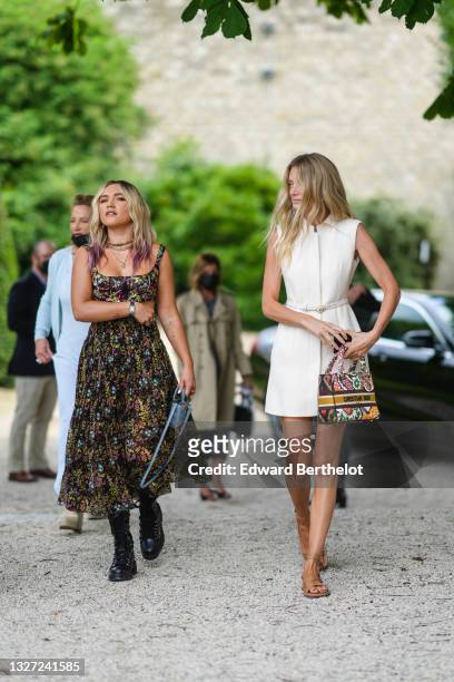 Guest wears a white matte sleeveless leather belted short dress from Dior, a white leather with green / red / orange / yellow embroidered pattern...