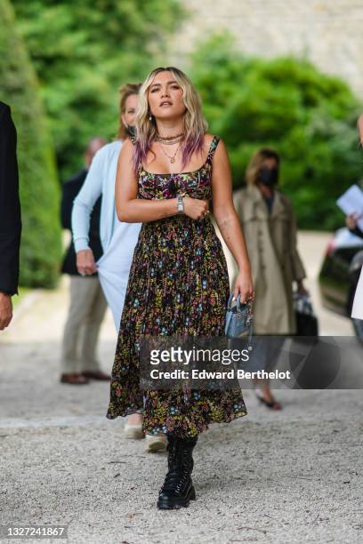 Florence Pugh wears gold pendant earrings, a gold J'Adior chain necklace, a multicolored pearls necklace, gold necklace, a black tulle with...