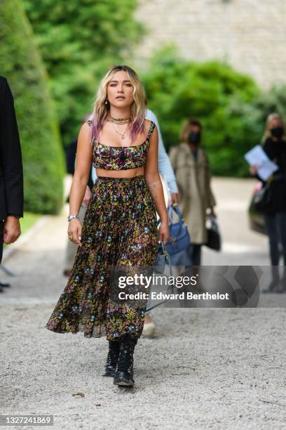 Florence Pugh wears gold pendant earrings, a gold J'Adior chain necklace, a multicolored pearls necklace, gold necklace, a black tulle with...