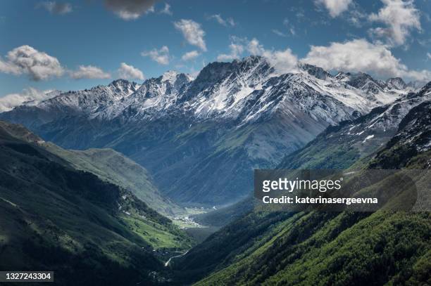 snowy peaks of the caucasus mountains - mountain stock pictures, royalty-free photos & images