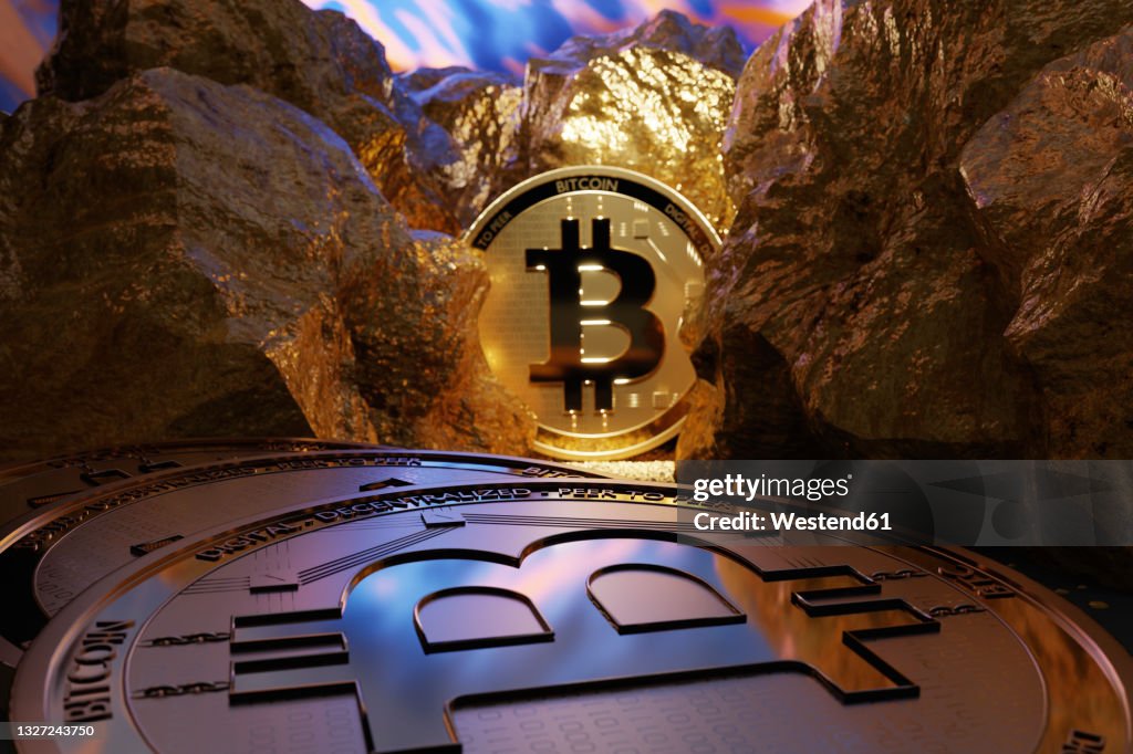 Shiny gold colored bitcoins amidst nuggets