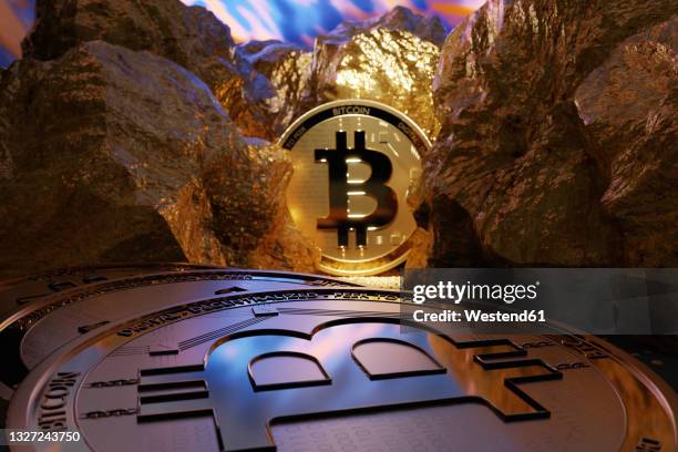 shiny gold colored bitcoins amidst nuggets - gold mining foto e immagini stock