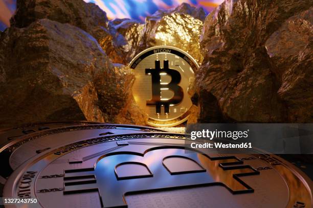 shiny gold colored bitcoins amidst nuggets - cryptocurrency mining 個照片及圖片檔