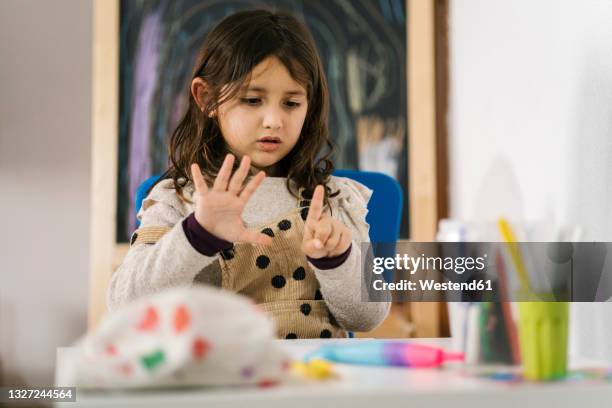 schoolgirl counting fingers while studying at home - counting stock pictures, royalty-free photos & images