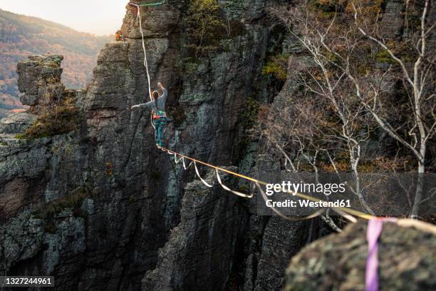 woman balancing while highlining at baden-baden, germany - slackline foto e immagini stock