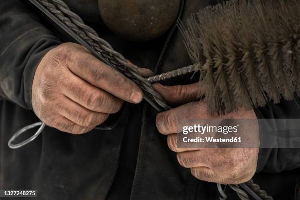 male chimney sweep holding work tools - chimney sweep stock pictures, royalty-free photos & images