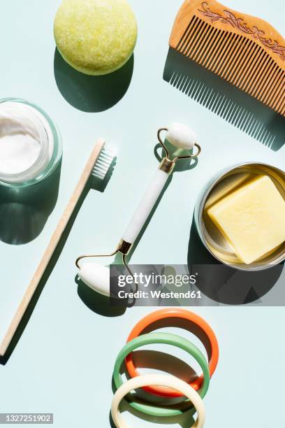 studio shot of wooden comb, bamboo toothbrush, colorful bracelets, organic soap, shampoo and other eco-friendly self-care products - toothbrush ストックフォトと画像