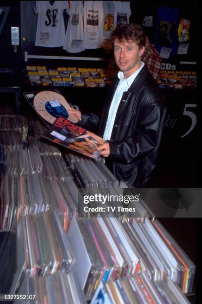 Radio and television presenter Nicky Campbell, known for hosting game show Wheel Of Fortune, shopping for records, circa 1996.