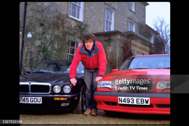 Television presenter Jeremy Clarkson, host of Jeremy Clarkson's Motorworld, photographed with his cars at home, circa January 1995.