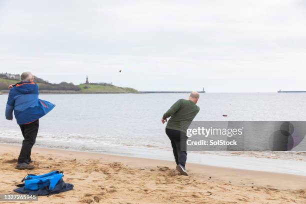 skimming stones in shields - skimming stones stock pictures, royalty-free photos & images