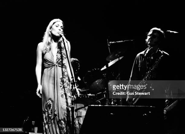 Joni Mitchell performs on stage with Tom Scott of the LA Express at the New Victoria Theatre, London, England, on April 21st, 1974.