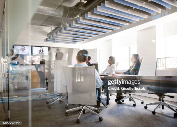 business team having video conference in office - boardroom stockfoto's en -beelden