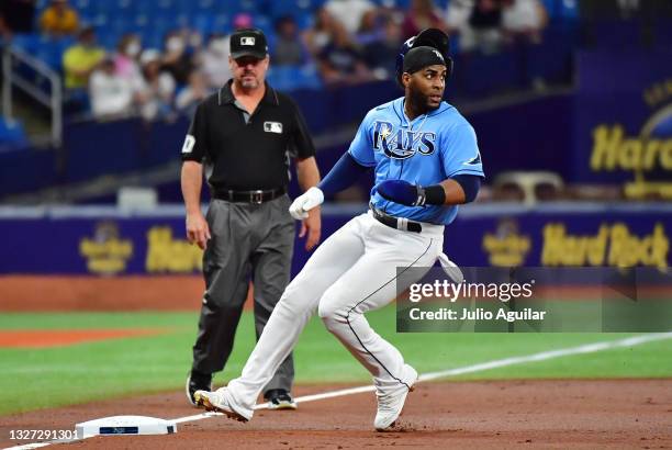 Yandy Diaz of the Tampa Bay Rays arrives safely at third in the second inning against the Cleveland Indians at Tropicana Field on July 05, 2021 in St...