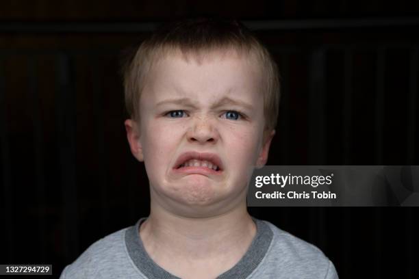 boy is disgusted and making faces - offense stock pictures, royalty-free photos & images