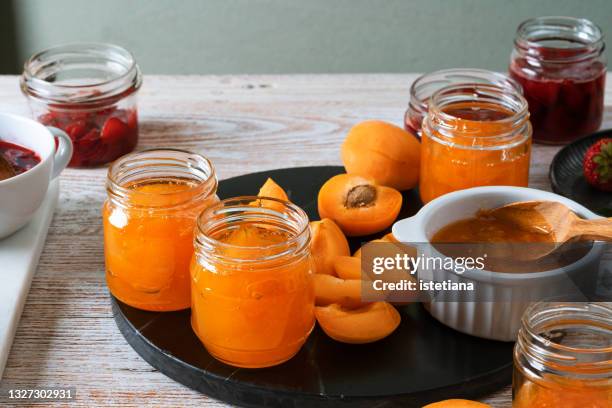 making strawberry and apricot jam. canning process - aprikosenkonfitüre stock-fotos und bilder