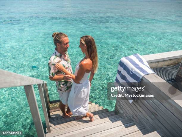 couple holding hands in the maldives, a staircase going down in the sea - heaven stairs stock pictures, royalty-free photos & images