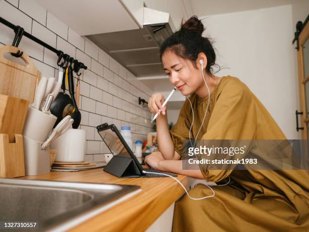 asian women freelance working in kitchen room. - lifehack stock pictures, royalty-free photos & images