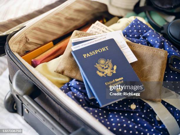 suitcase and passport - covid 19 vaccine card stock pictures, royalty-free photos & images
