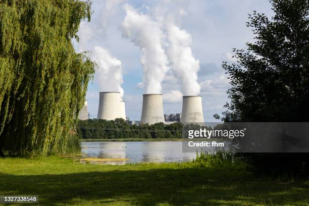 three large chimneys at a power station - luftverschmutzung stock-fotos und bilder