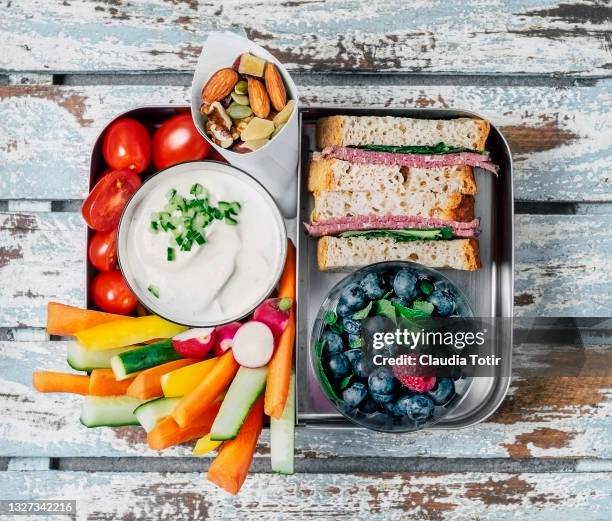 lunch box (sandwich, vegetables, berries and yogurt) on wooden, blue background - lunchlåda bildbanksfoton och bilder