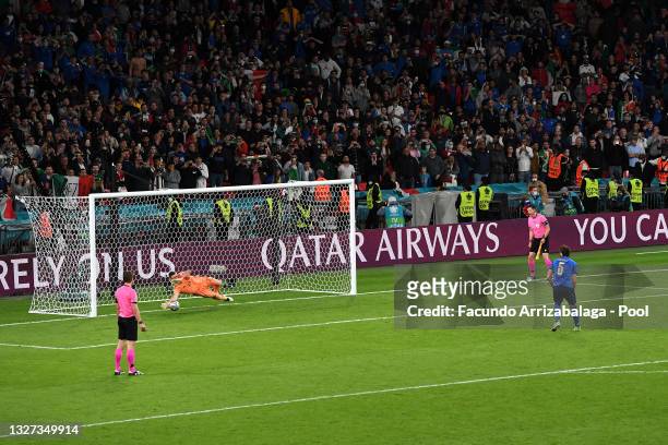 Unai Simon of Spain saves the first penalty from Manuel Locatelli of Italy during a penalty shoot out during the UEFA Euro 2020 Championship...