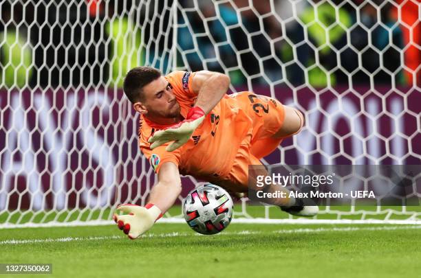 Unai Simon of Spain saves the first Italy penalty taken by Manuel Locatelli in a penalty shoot out during the UEFA Euro 2020 Championship Semi-final...