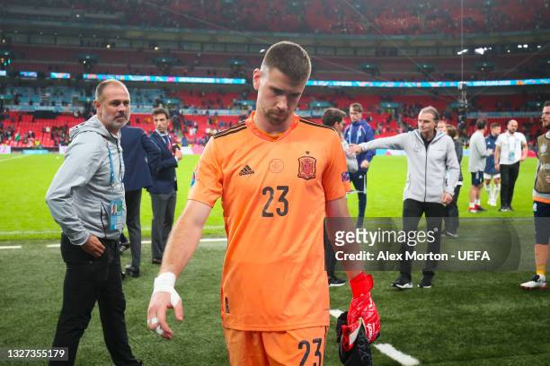 Unai Simon of Spain looks dejected as he leaves the field after defeat in the UEFA Euro 2020 Championship Semi-final match between Italy and Spain at...