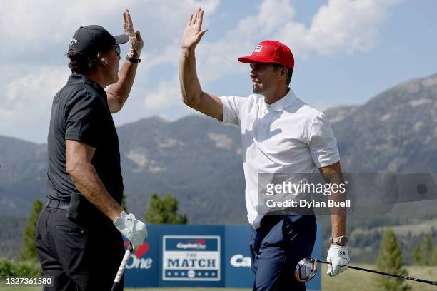 Phil Mickelson and Tom Brady high five on the third green during Capital One's The Match at The Reserve at Moonlight Basin on July 06, 2021 in Big...