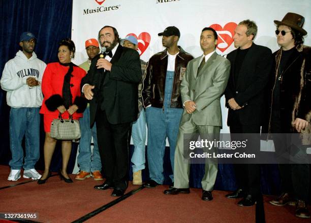 Italian operatic tenor Luciano Pavarotti stands on stage with American singer, songwriter, and pianist Aretha Franklin , Shawn Stockman, Michael...