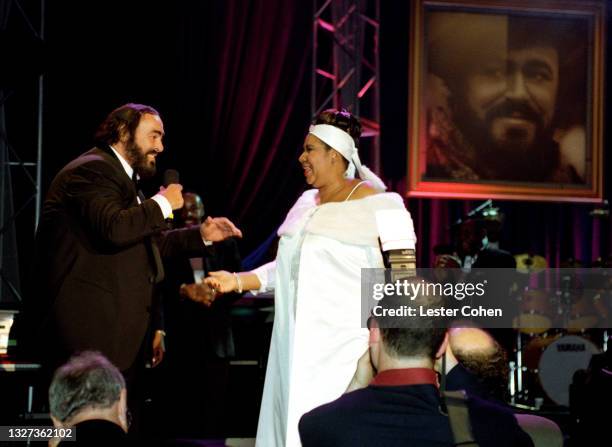 Italian operatic tenor Luciano Pavarotti and American singer, songwriter, and pianist Aretha Franklin stand on stage during the 1998 MusiCares...