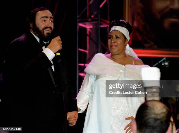 Italian operatic tenor Luciano Pavarotti and American singer, songwriter, and pianist Aretha Franklin stand on stage during the 1998 MusiCares...