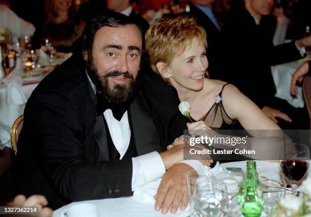 Italian operatic tenor Luciano Pavarotti sits with a friend at the 1998 MusiCares benefit dinner on February 23, 1998 in New York, New York....