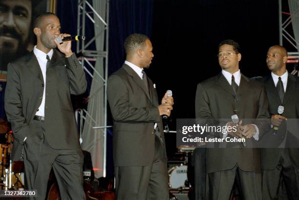 Shawn Stockman, Michael McCary, Nathan Morris and Wayne Morris of the American vocal harmony group Boys II Men sing at the 1998 MusiCares benefit...