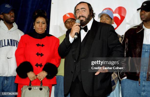 Italian operatic tenor Luciano Pavarotti stands on stage with Michael Green, American singer, songwriter, and pianist Aretha Franklin , Shawn...