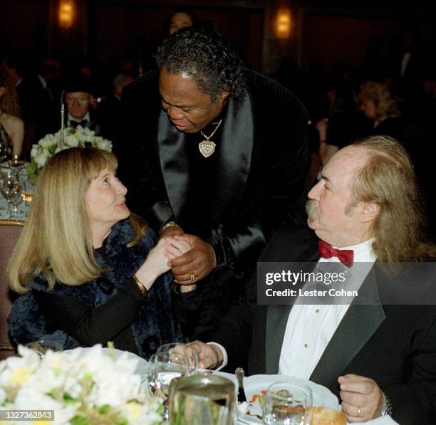 American vocalist Sam Moore visits with American singer-songwriter and musician David Crosby and his wife Jan Dance at the 1998 MusiCares benefit...