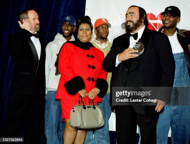 Italian operatic tenor Luciano Pavarotti stands on stage with Michael Green, American singer, songwriter, and pianist Aretha Franklin , Shawn...
