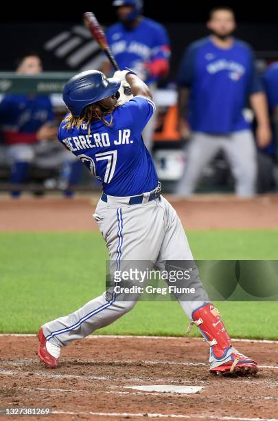 Vladimir Guerrero Jr. #27 of the Toronto Blue Jays hits a home run in the ninth inning against the Baltimore Orioles at Oriole Park at Camden Yards...