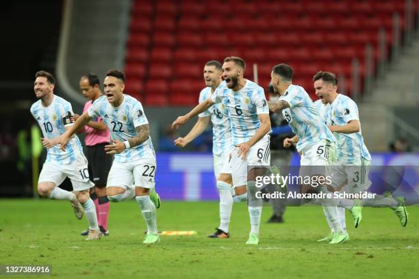 Lionel Messi, Lautaro Martinez and German Pezzella of Argentina celebrate with teammates winning a penalty shootout after a semi-final match of Copa...