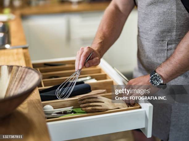 young man cooking italian meal in home kitchen - drawer stock pictures, royalty-free photos & images