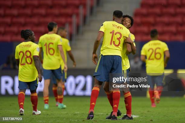 Yerry Mina of Colombia greets teammate Juan Cuadrado after losing a penalty shootout after a semi-final match of Copa America Brazil 2021 between...