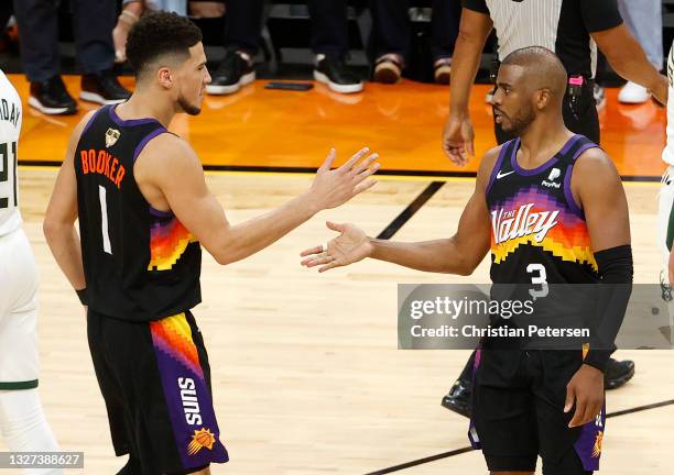 Devin Booker and Chris Paul of the Phoenix Suns celebrate during the second half in Game One of the NBA Finals against the Milwaukee Bucks at Phoenix...