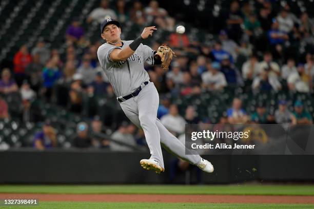 Gio Urshela of the New York Yankees makes a throw to first base in the eighth inning of the game against the Seattle Mariners at T-Mobile Park on...