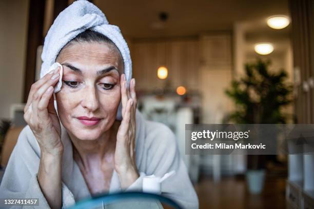 a woman who takes care of her beauty during her stay at home. vitiligo. - mature women skincare stock pictures, royalty-free photos & images