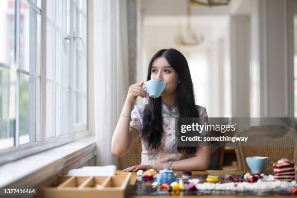 asian girls drinking afternoon tea - the cheongsam stock pictures, royalty-free photos & images