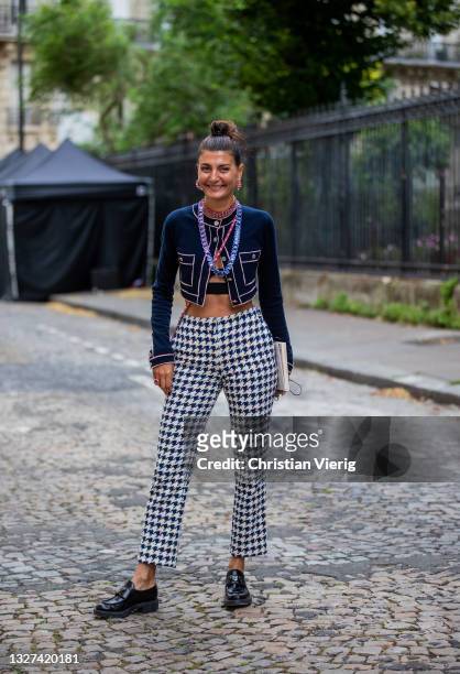 Giovanna Battaglia Engelbert is seen wearing cropped top, pink Chanel bag, checkered pants outside Chanel on July 06, 2021 in Paris, France.